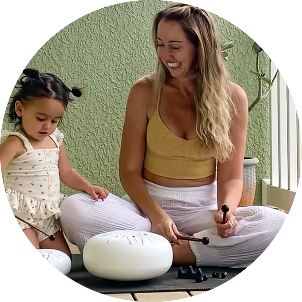 Mother and toddler playing a Panda Drum at home