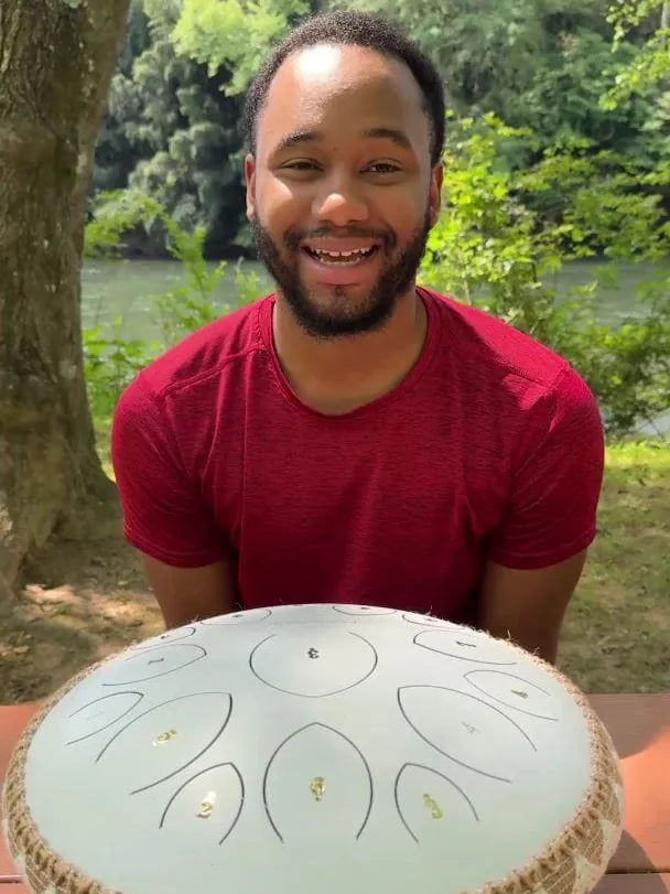 A customer playing his Panda Drum outdoors