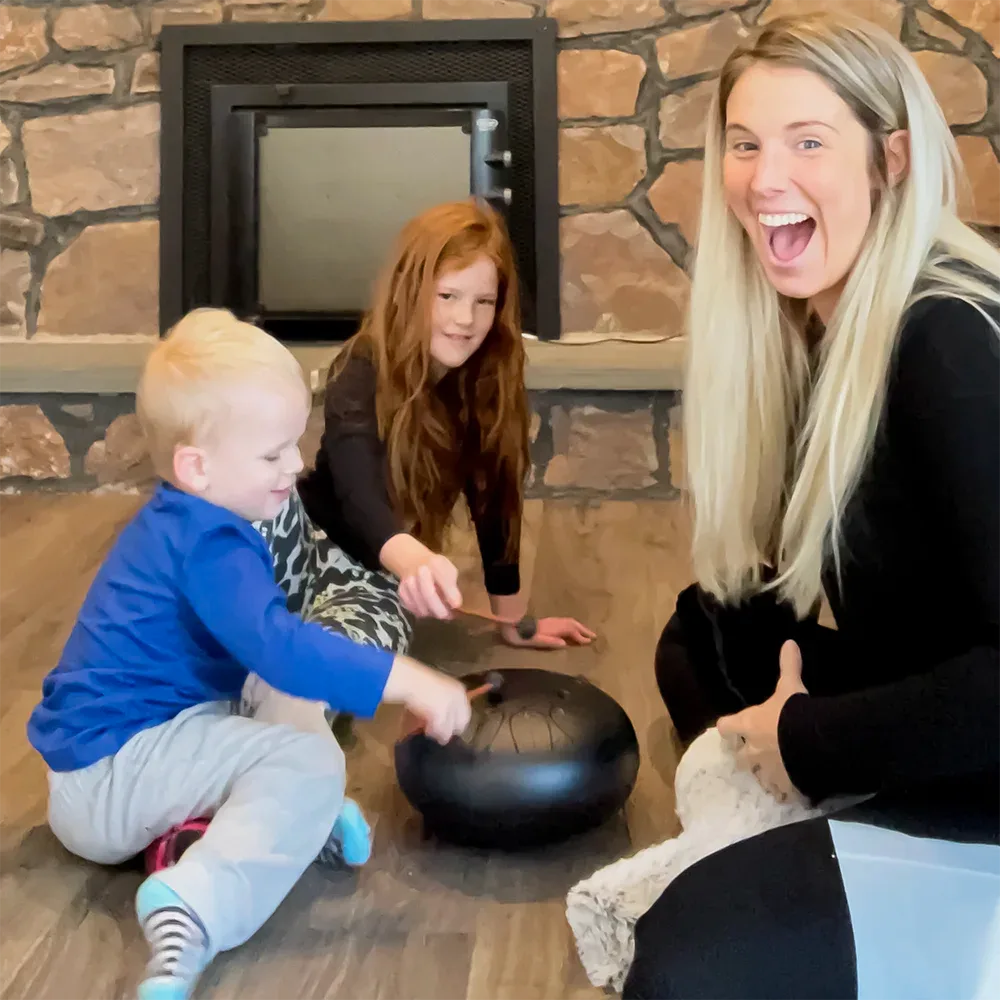 A family playing the Panda Drum together