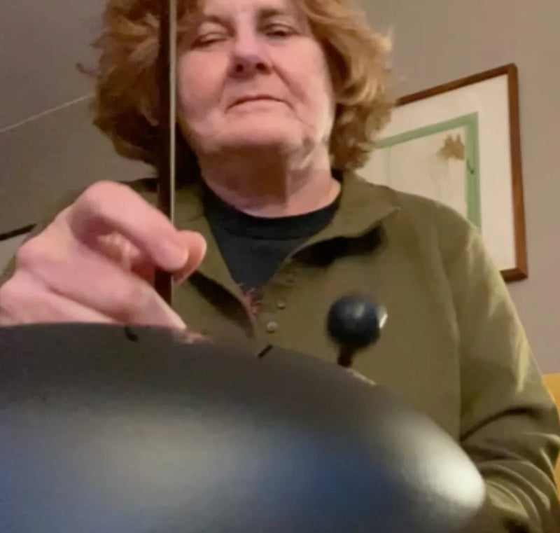 Grandmother playing a Panda Drum