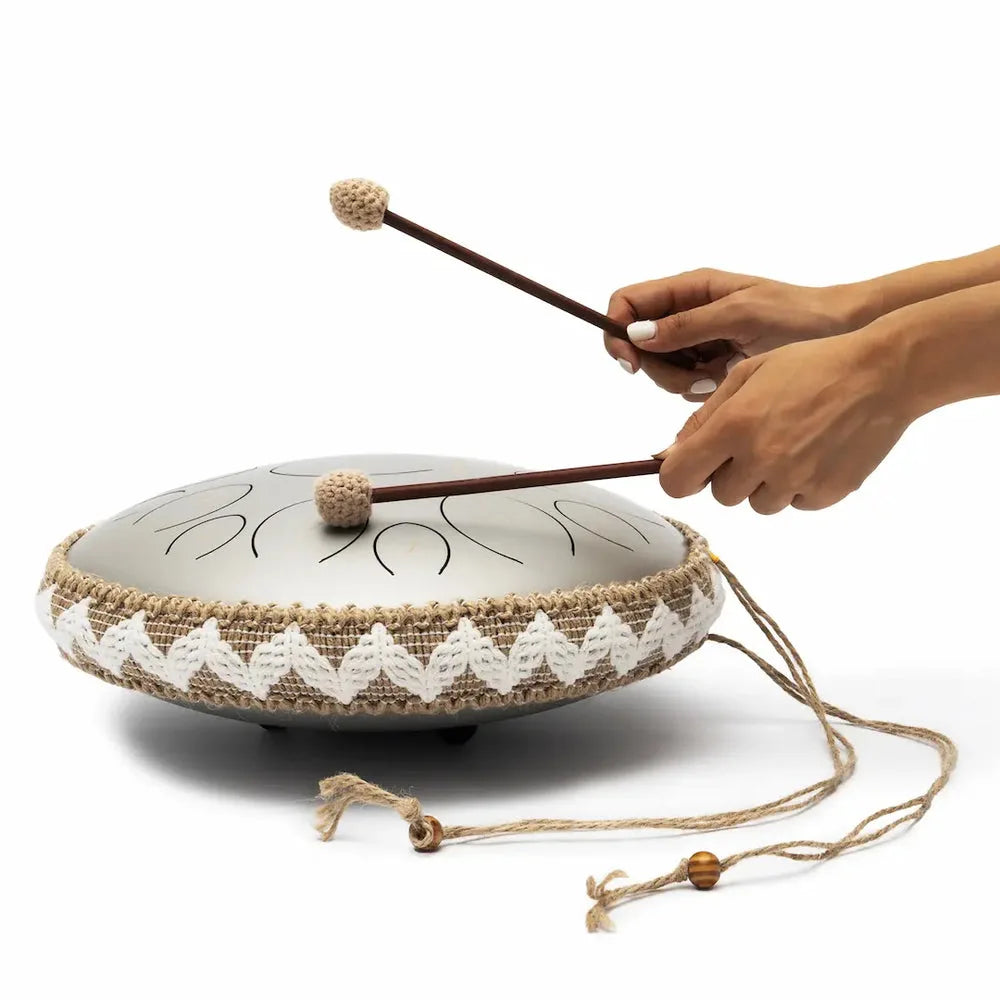 Hands playing the Panda Drum Pro with mallets